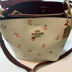 Coach women small town bucket ,pebble leather heart floral bag,white and maroon